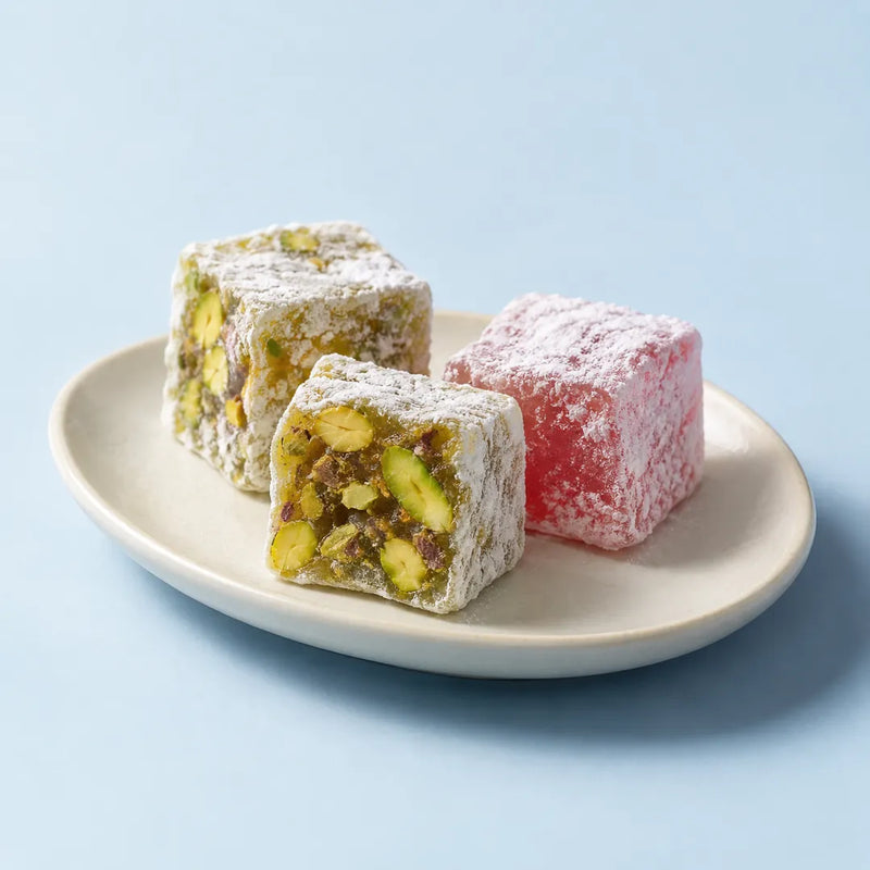Pistachio and rose Turkish delight on a small cream plate.